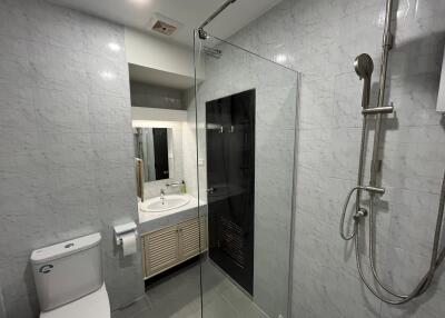 Modern bathroom with glass shower and bright lighting