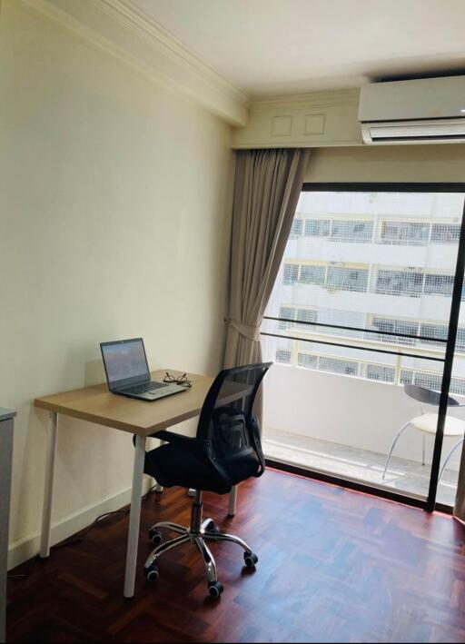 Modern bedroom with workspace and city view