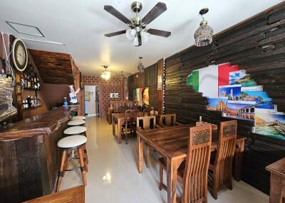 Spacious dining area with rustic wooden furniture and a well-equipped bar