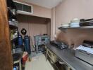 Compact commercial kitchen with various appliances and storage shelves