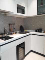 Modern kitchen with white cabinetry and built-in appliances