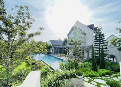 Luxurious backyard with swimming pool and lush greenery