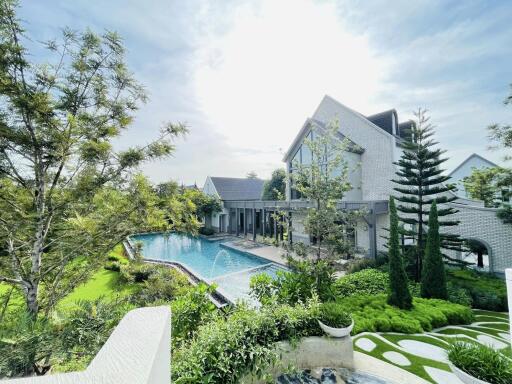 Luxurious backyard with swimming pool and lush greenery