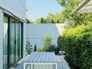 Modern outdoor patio with wooden decking and garden view