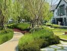 Lush green garden pathway leading to a modern house