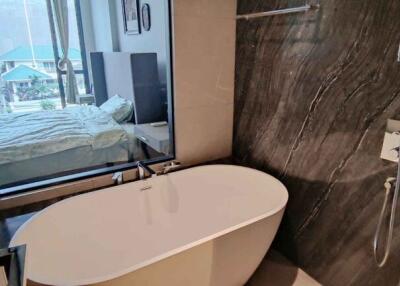 Spacious modern bathroom with freestanding bathtub and large mirror