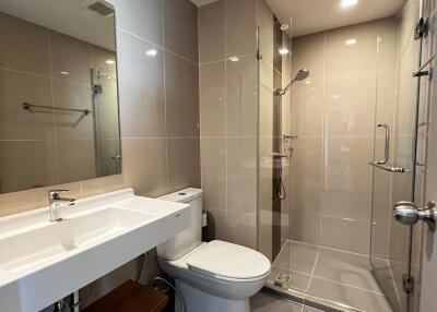 Modern bathroom with spacious glass shower enclosure and sleek vanity