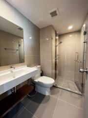 Modern bathroom with spacious glass shower enclosure and sleek vanity