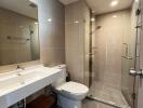 Modern bathroom with spacious glass shower enclosure and sleek vanity