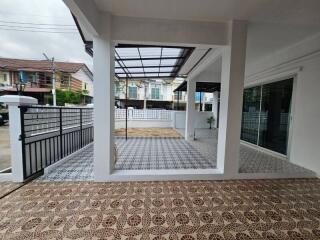 Spacious covered porch with decorative tiled flooring and multiple access points