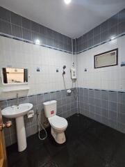 Modern bathroom interior with dark tiled flooring