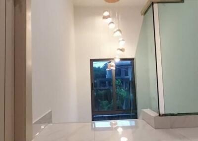 Elegant modern hallway in residential home with marble flooring and stylish ceiling lights