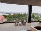 Spacious balcony with scenic river view and outdoor seating