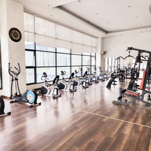 Spacious home gym with modern equipment and large windows