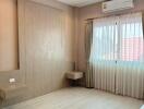 Spacious and well-lit bedroom with modern amenities