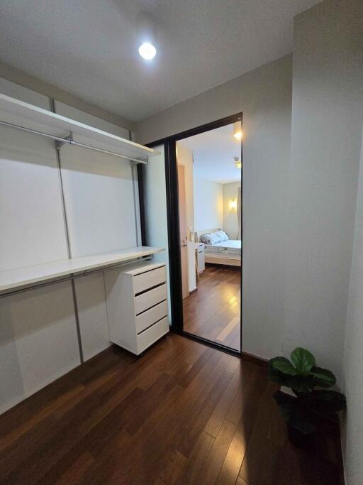 Spacious bedroom with wooden flooring and built-in wardrobe
