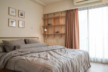 Cozy and well-lit bedroom with stylish wooden furniture