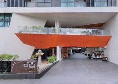Modern residential building entrance with unique orange awning