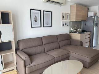 Modern living room with sectional sofa and integrated kitchen