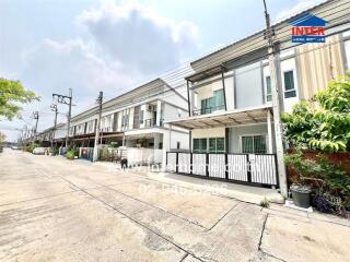 Row of modern townhouses with clear skies