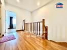 Spacious hallway with wooden flooring and natural lighting