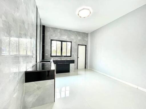 Modern kitchen interior with black countertops and spacious layout