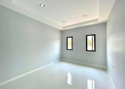 Spacious and bright empty living room with high ceiling and large windows