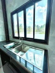 Modern kitchen with large window overlooking a scenic view