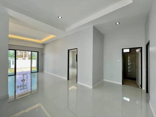 Spacious and modern living room with high gloss floor and ample natural light