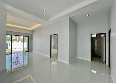 Spacious and modern living room with high gloss floor and ample natural light