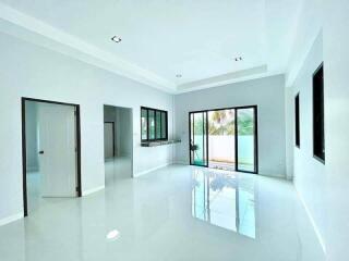 Spacious and bright living room with large windows and glossy floor