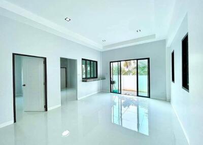 Spacious and bright living room with large windows and glossy floor