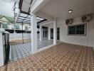 Covered outdoor space in a residential building with decorative tile flooring
