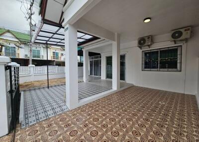 Covered outdoor space in a residential building with decorative tile flooring