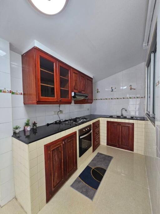 Spacious kitchen with wooden cabinets and modern appliances