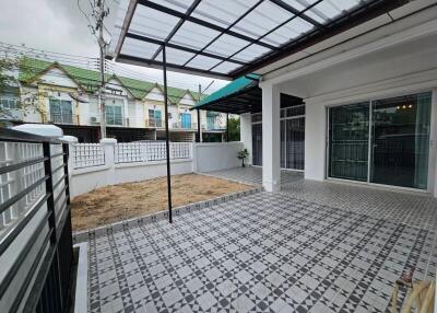 Spacious covered patio area with patterned tile flooring