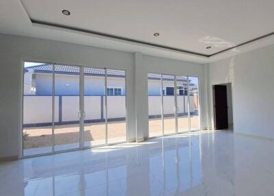 Spacious and modern living room with large windows and glossy floor