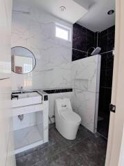 Modern bathroom with marble walls and contemporary fixtures