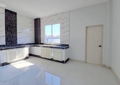Modern kitchen with marble finishes and scenic view