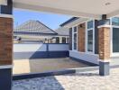 Modern residential home exterior with spacious patio and textured paving