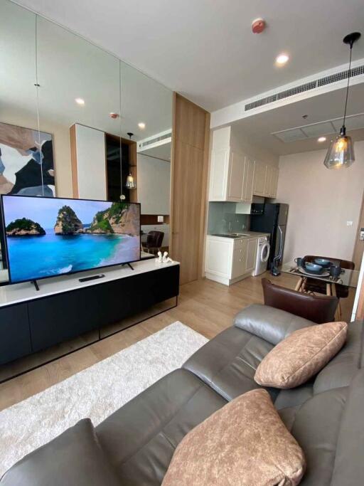 Modern living room with fitted kitchen and entertainment area