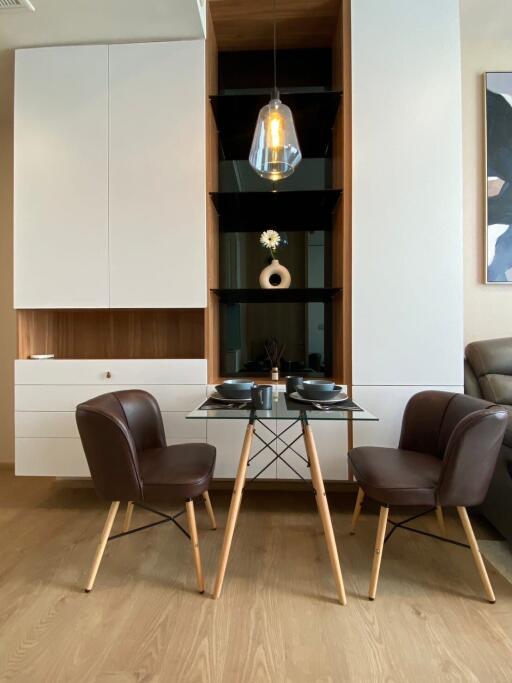Stylish modern dining area with elegant furniture and built-in shelving