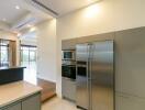 Modern kitchen with stainless steel appliances and ample lighting