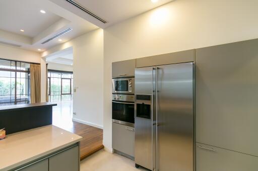 Modern kitchen with stainless steel appliances and ample lighting