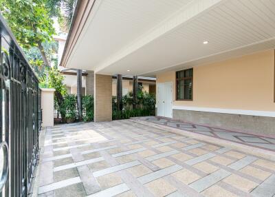 Spacious and well-lit covered driveway leading to a home entrance