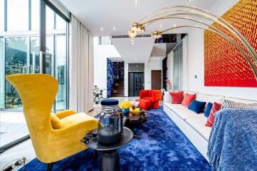 Modern and vibrant living room with floor-to-ceiling windows and colorful interior