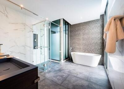 Luxurious modern bathroom with a freestanding tub, glass shower, and elegant finishes