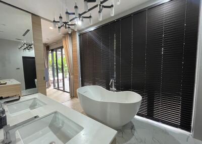 Spacious modern bathroom with freestanding tub and dual sinks