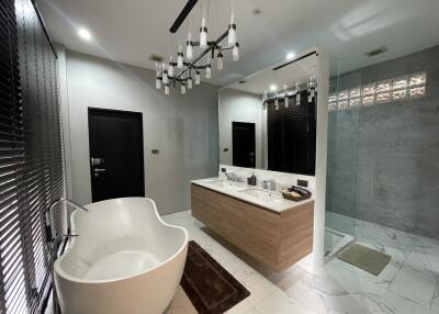 Spacious modern bathroom with freestanding tub and dual vanities