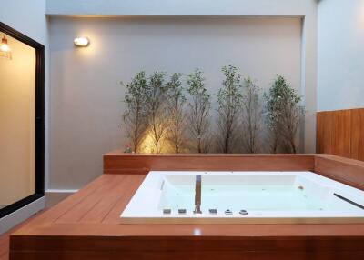 Luxurious modern bathroom with a large jacuzzi and atmospheric lighting